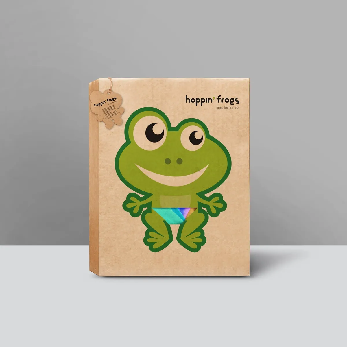 hoppin' frogs kraft gift box (plain variant) — large green frog mascot on natural cardboard with die-cut window; same frog hang tag, cleaner face view without product visible