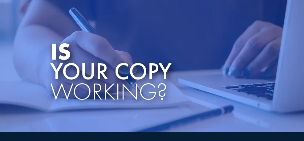 Close-up of hands writing in a notebook beside a laptop, tinted blue, with the words 'Is your copy working?'