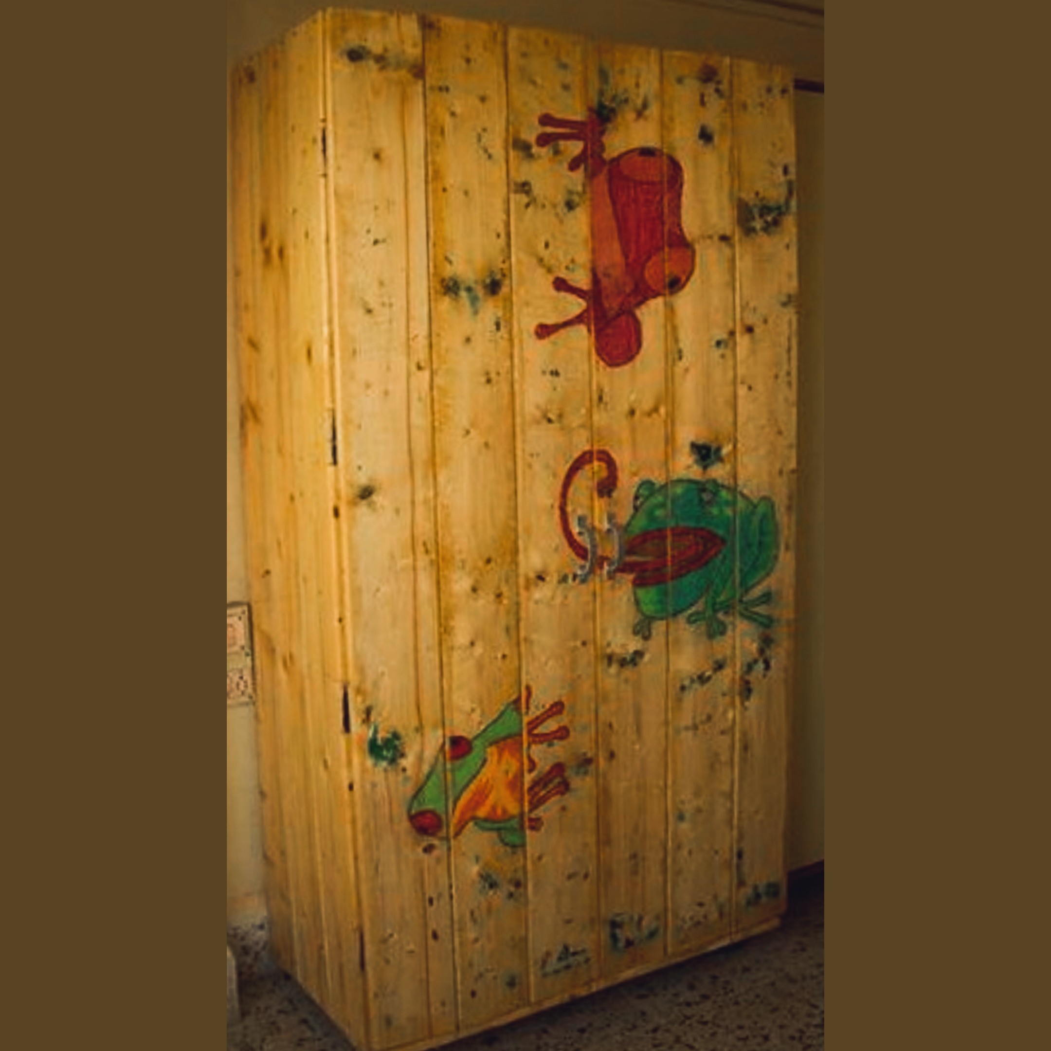 Full-height pinewood wardrobe with hand-painted colourful frogs on the doors — Nabina's first major carpentry project