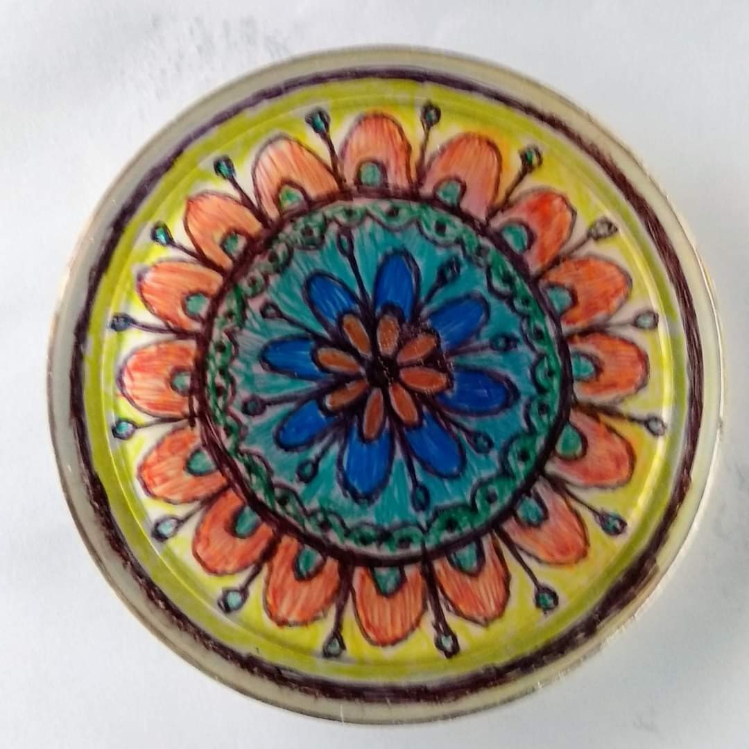 Round resin mandala — orange petals, teal centre ring, blue inner flower, yellow background, set in tin lid