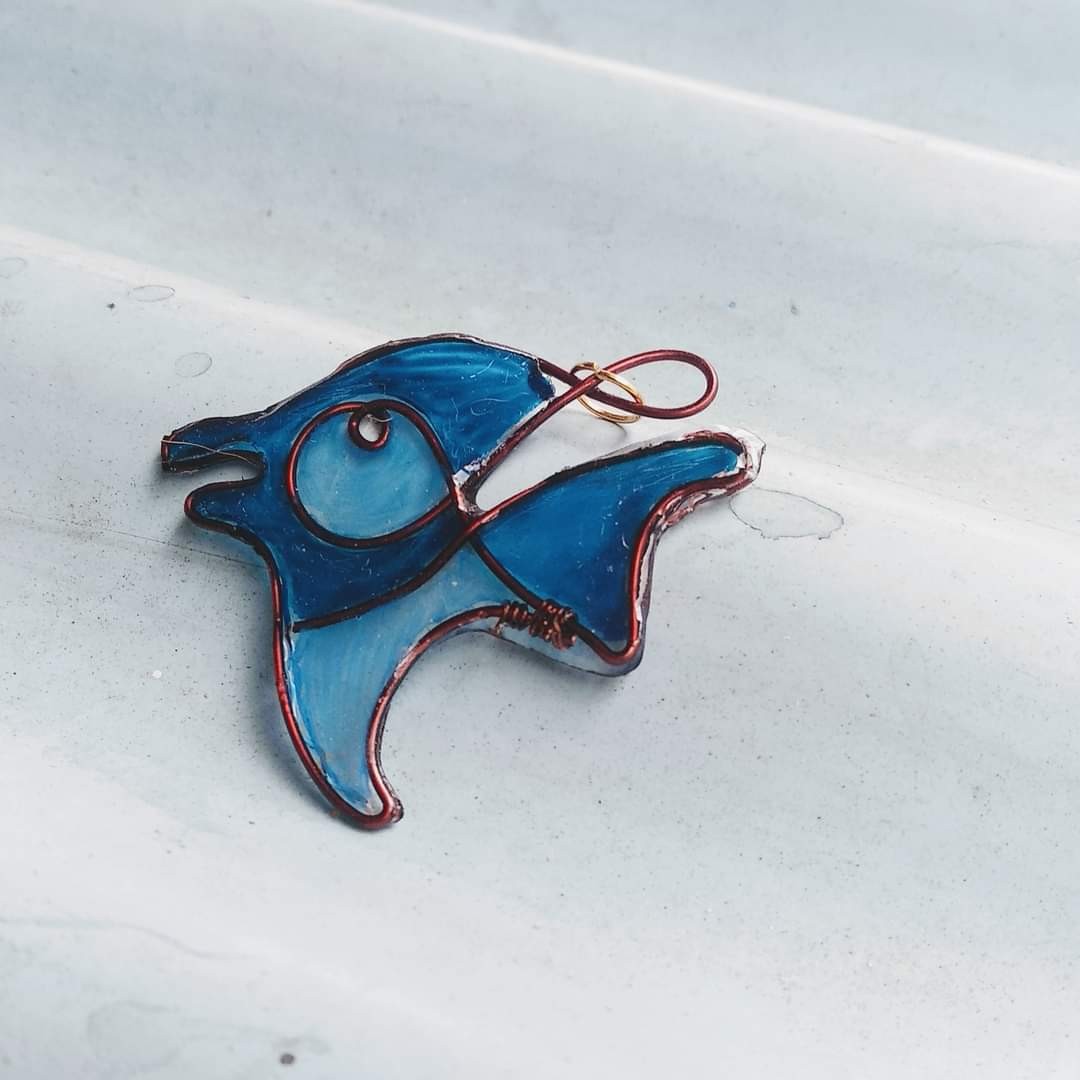 Blue resin fish pendant with copper wire frame — bold expressive fish shape with circular eye detail